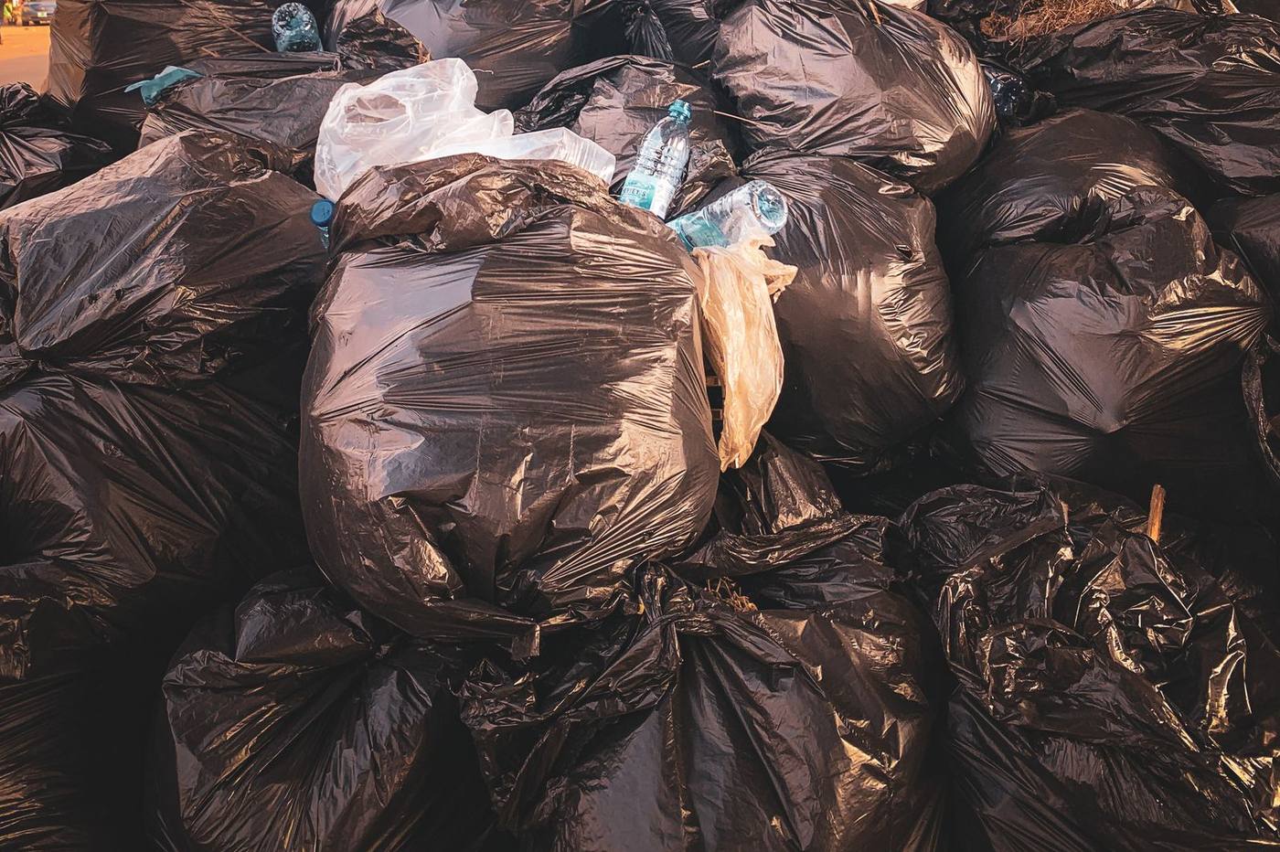 A pile of full black trash bags